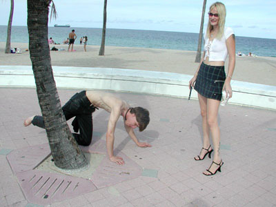 Ordering her slave to pee like a dog in public