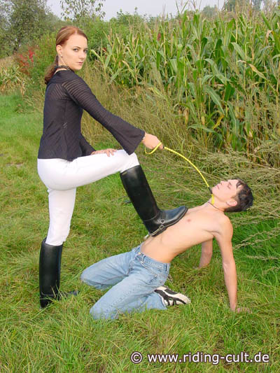 Riding Mistress dominating the slave out in the open