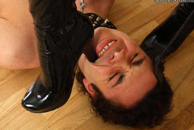 Digging her boot heels into her slave's mouth