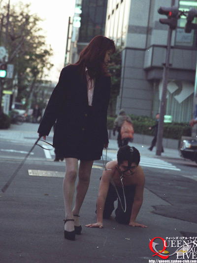 Mistress with her puppy slave at the streets of Japan